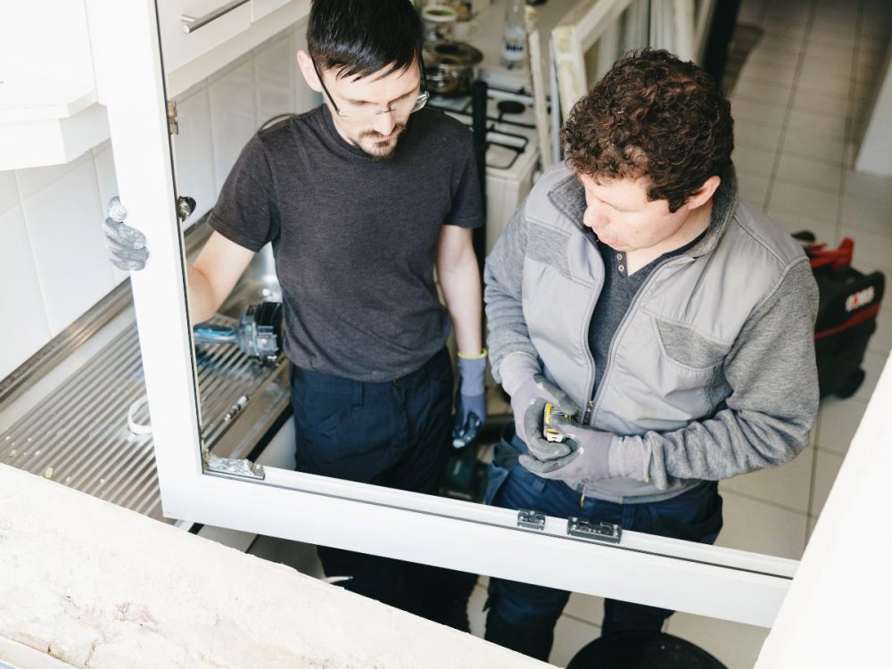 Is Strata Responsible for Windows in WA? What to Check Before Replacement 2 Installer replacing an aluminium window frame
