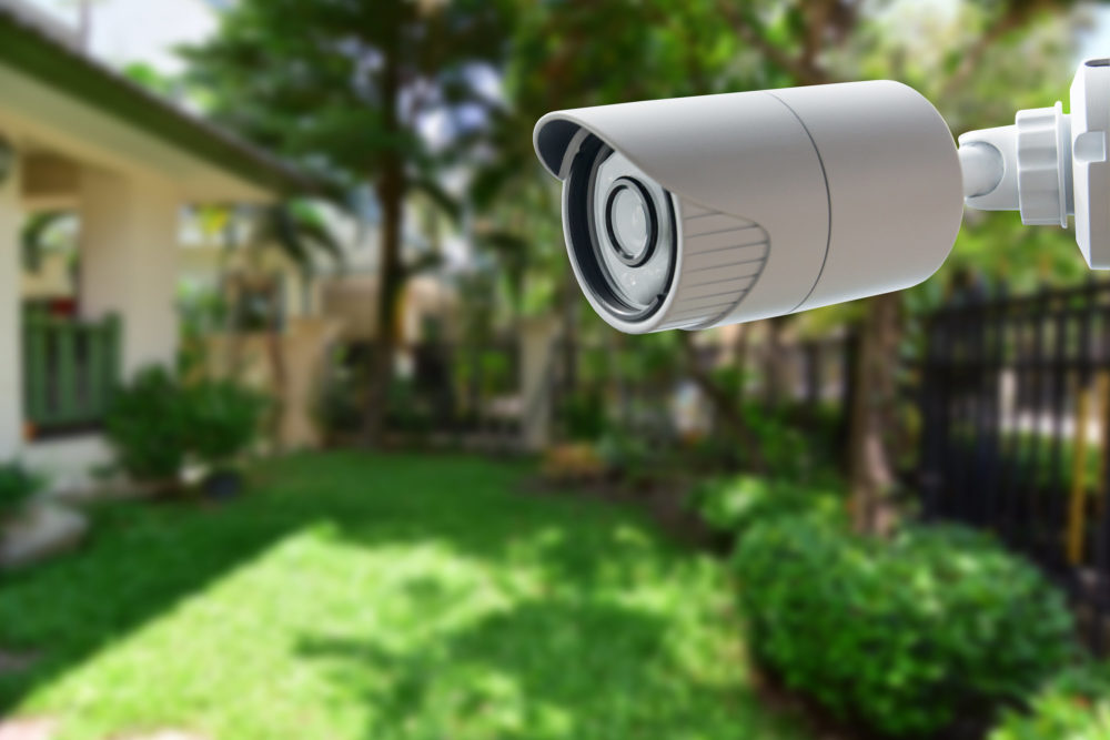 An outdoor security camera set up in a backyard