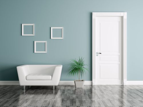 A door with a white door frame in a blue wall