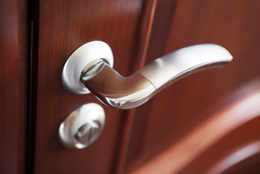 A silver door handle with a separate door lock