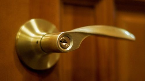 A gold door handle with a keyhole