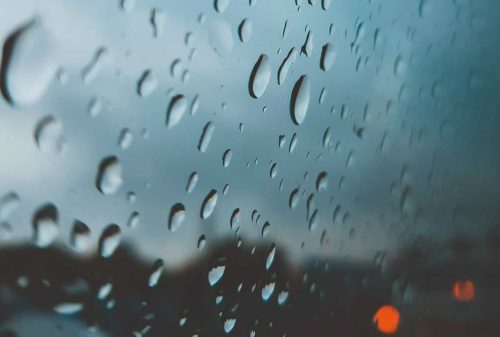 A frameless window in the rain