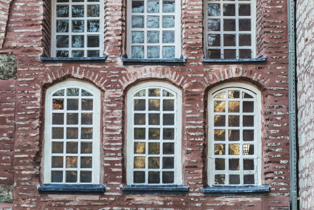 Six windows on a clay brick wall